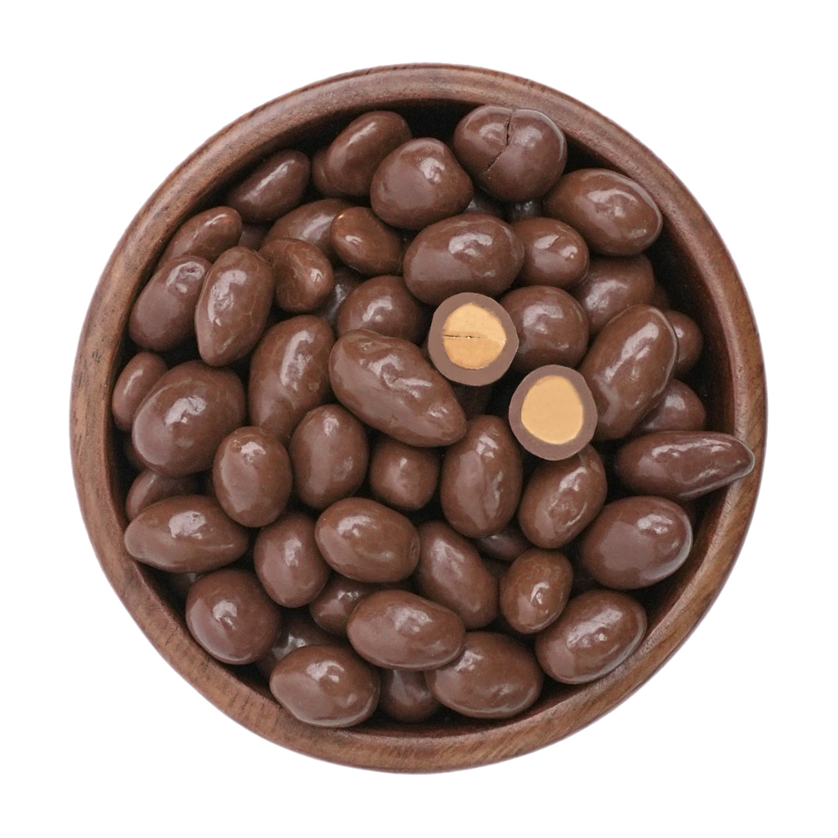 Mit Vollmilch schokoladenüberzogene erdnüsse in einer dunklen Holzschale